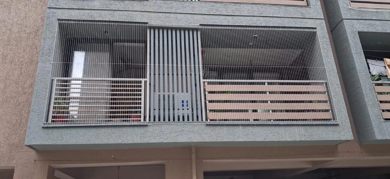 Invisible grill installation on a residential building facade